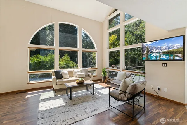 a living room with furniture tv and a large window