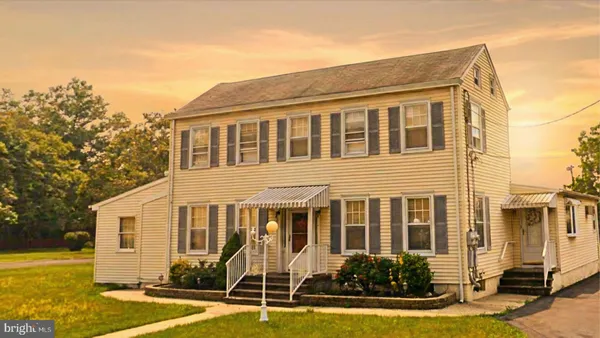a front view of a house with swimming pool and porch