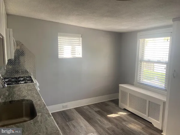 a bathroom with a sink toilet and window