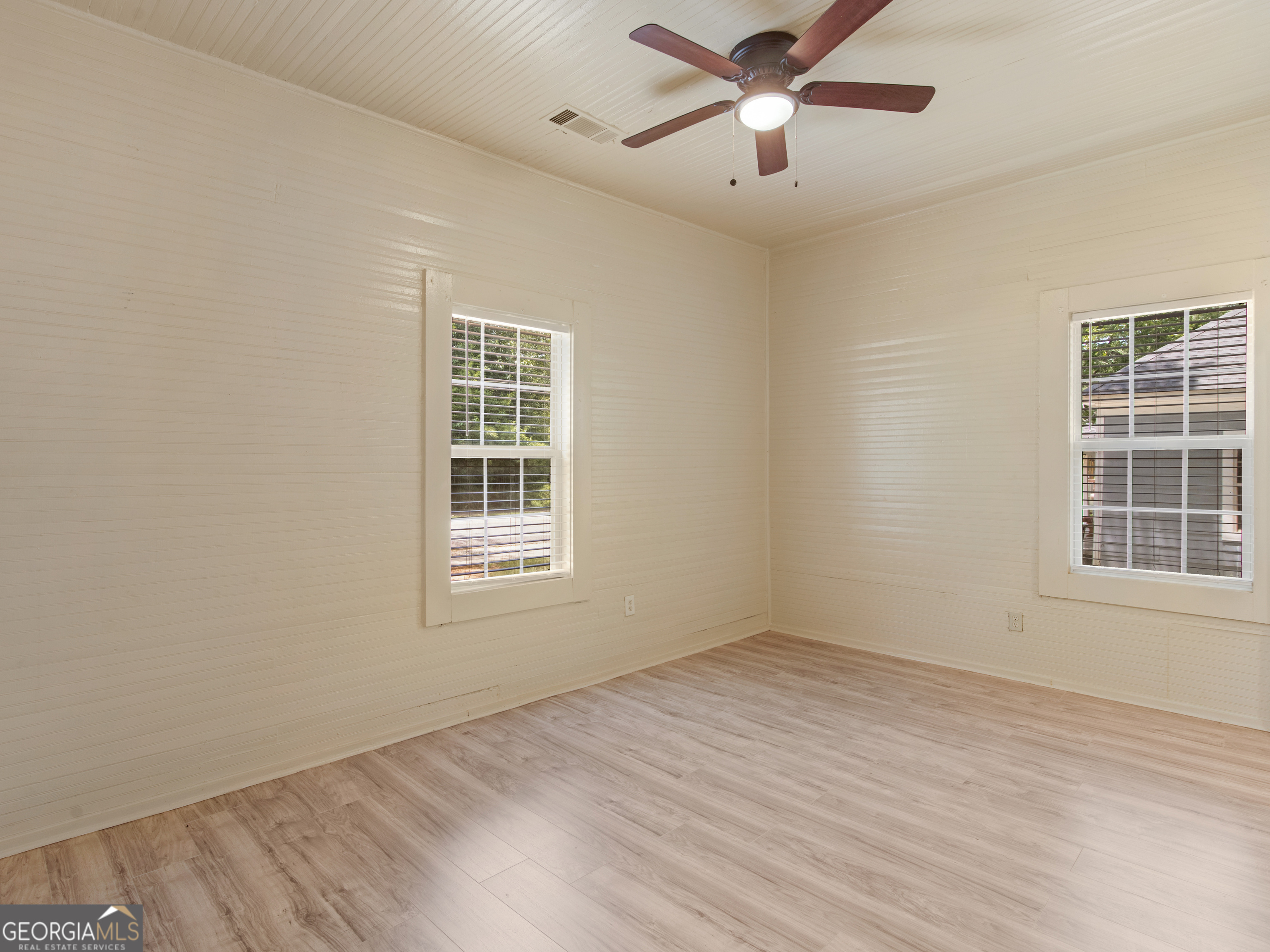 245 Atlanta Street Barnesville, GA 30204 - Photo 11 of 36 a view of empty room with wooden floor and fan