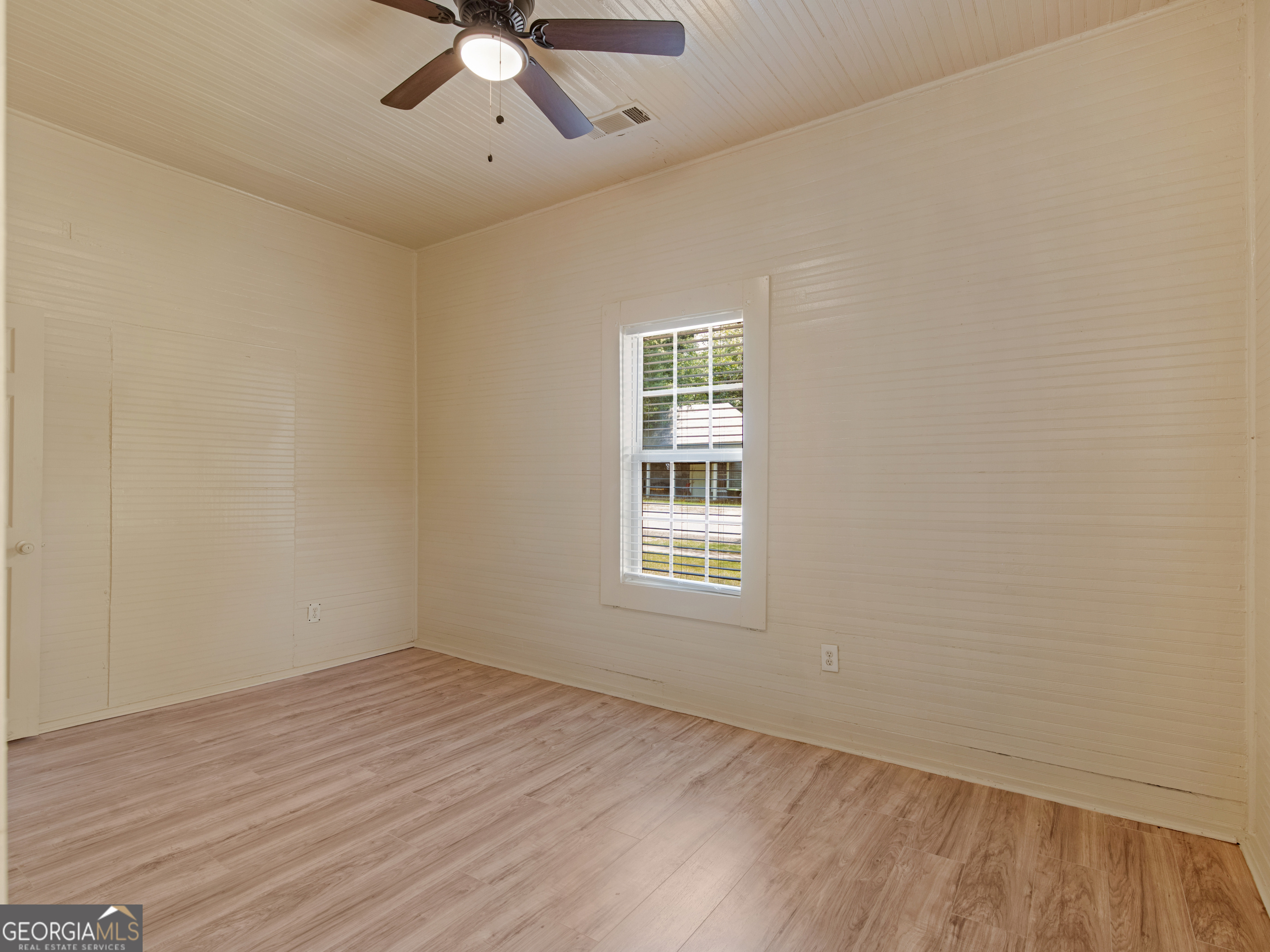 245 Atlanta Street Barnesville, GA 30204 - Photo 12 of 36 wooden floor in an empty room with a window