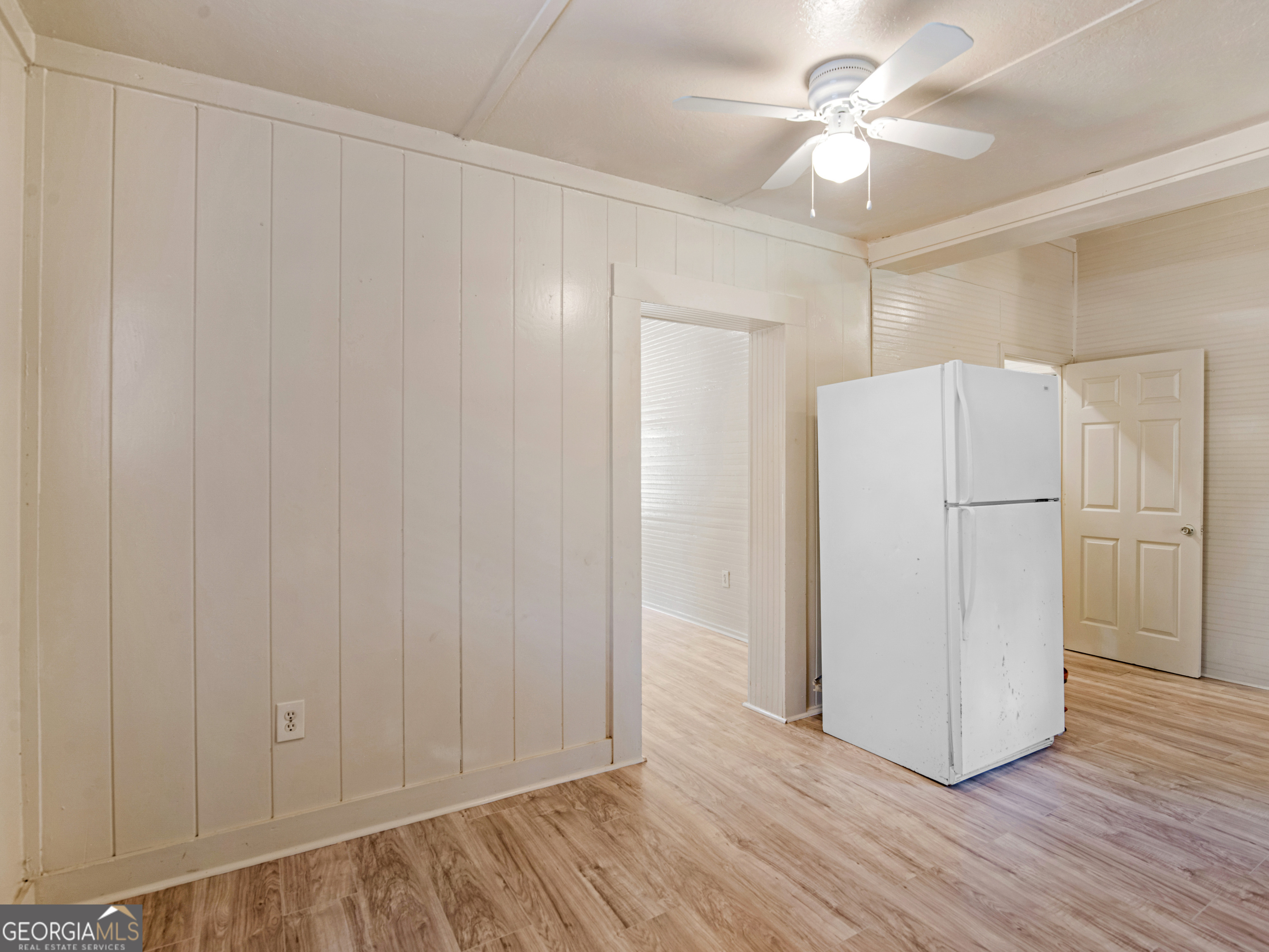 245 Atlanta Street Barnesville, GA 30204 - Photo 18 of 36 a view of a refrigerator in kitchen and white cabinets