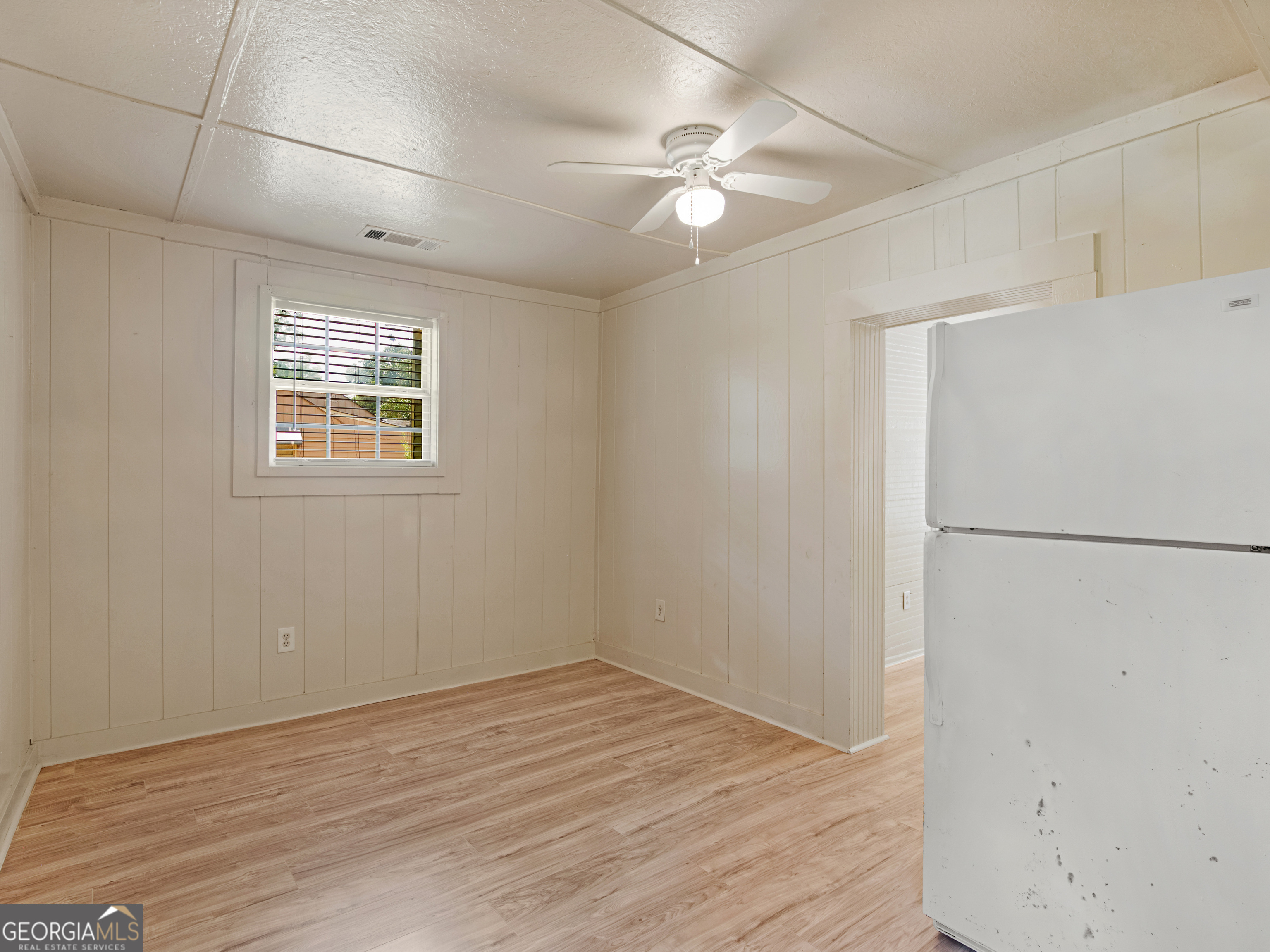 245 Atlanta Street Barnesville, GA 30204 - Photo 19 of 36 a view of an empty room with wooden floor and a window