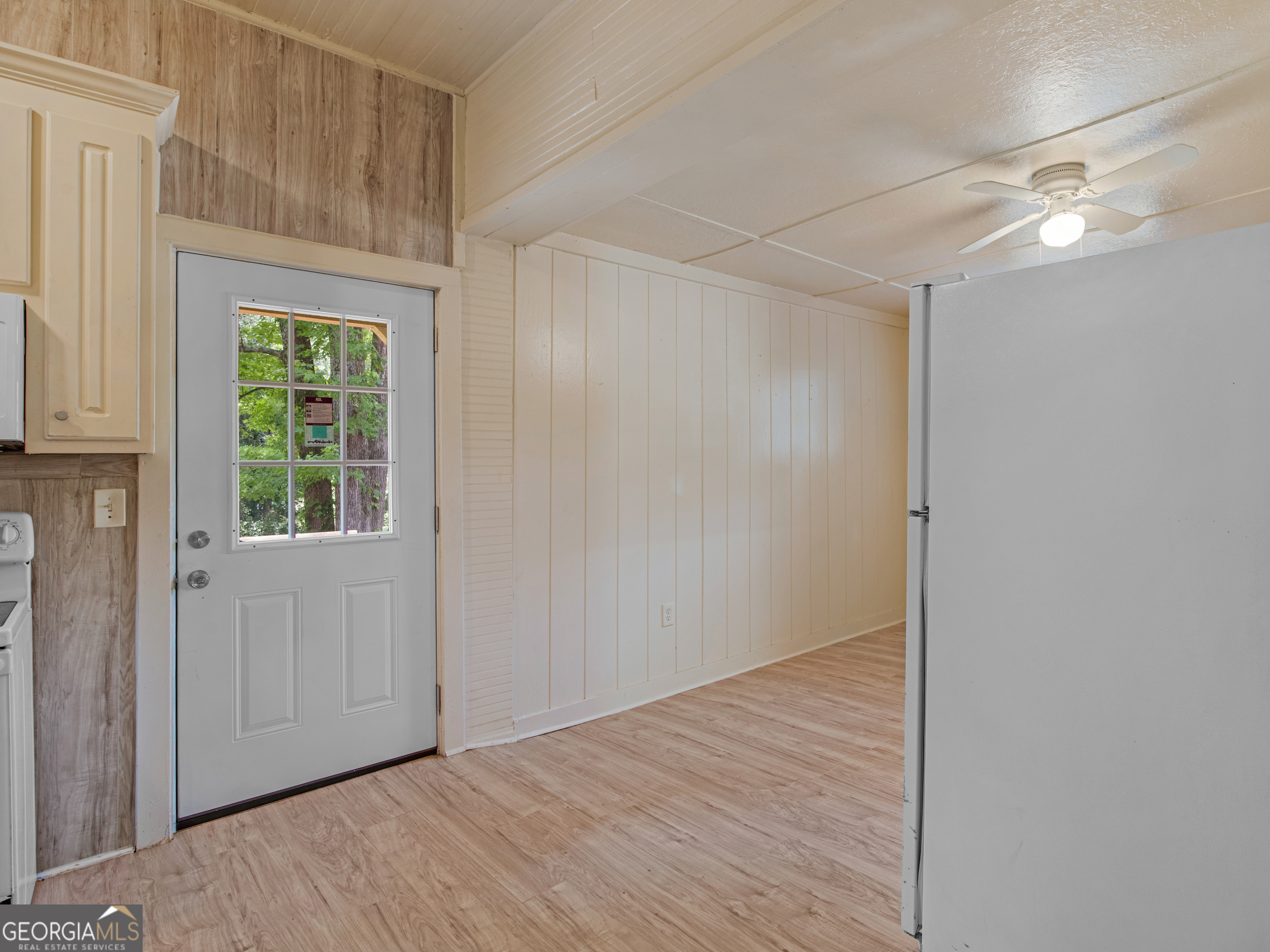 245 Atlanta Street Barnesville, GA 30204 - Photo 23 of 36 a view of an empty room with wooden floor and a window