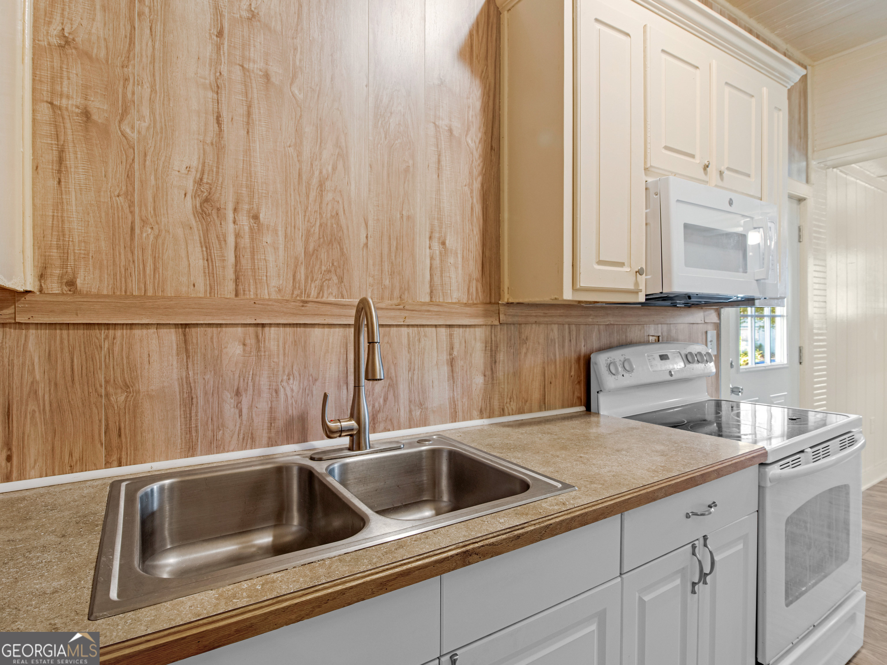 245 Atlanta Street Barnesville, GA 30204 - Photo 25 of 36 a kitchen with stainless steel appliances white cabinets and a sink