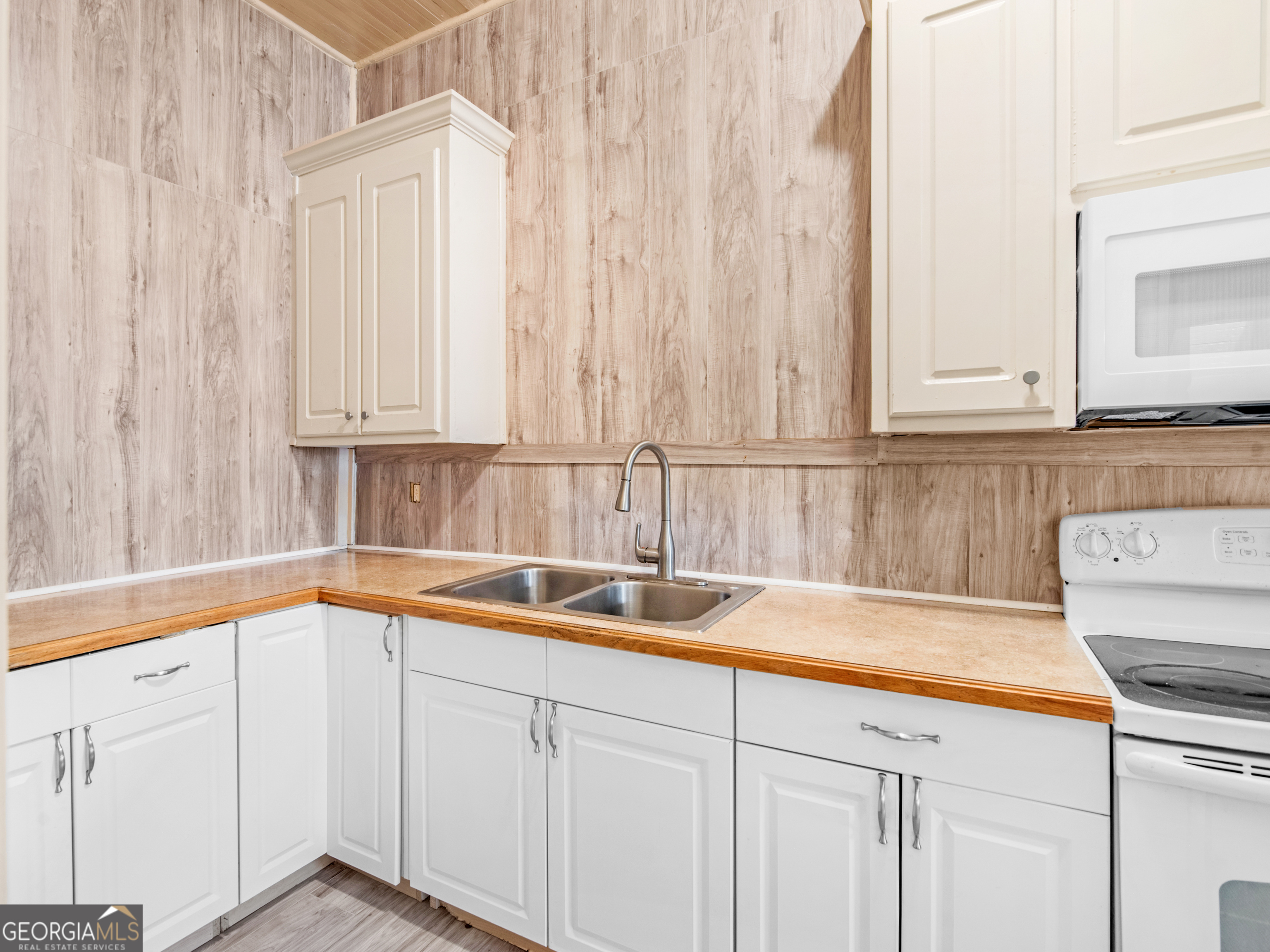 245 Atlanta Street Barnesville, GA 30204 - Photo 26 of 36 a kitchen with a sink and cabinets