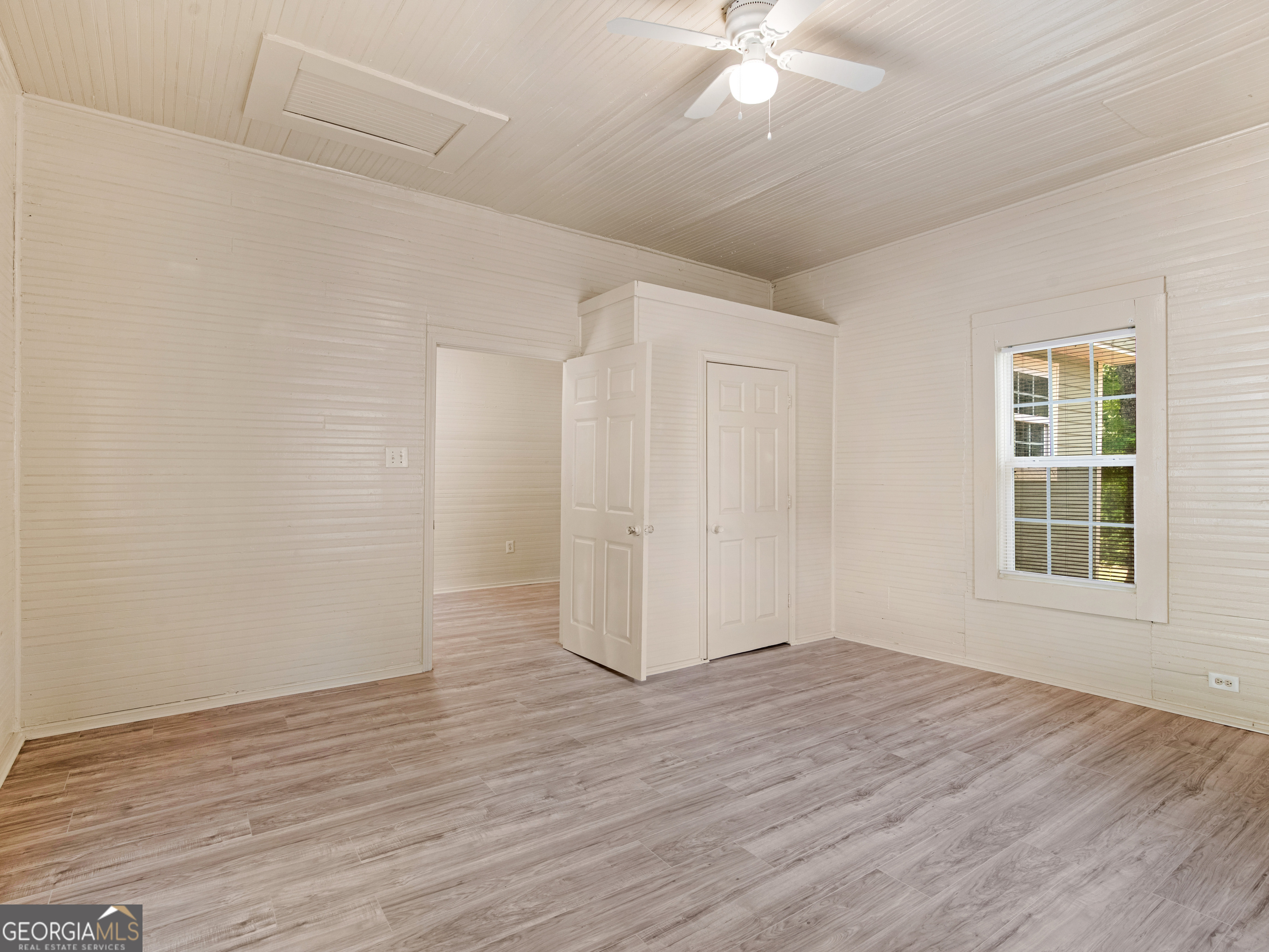 245 Atlanta Street Barnesville, GA 30204 - Photo 8 of 36 wooden floor in an empty room with a window