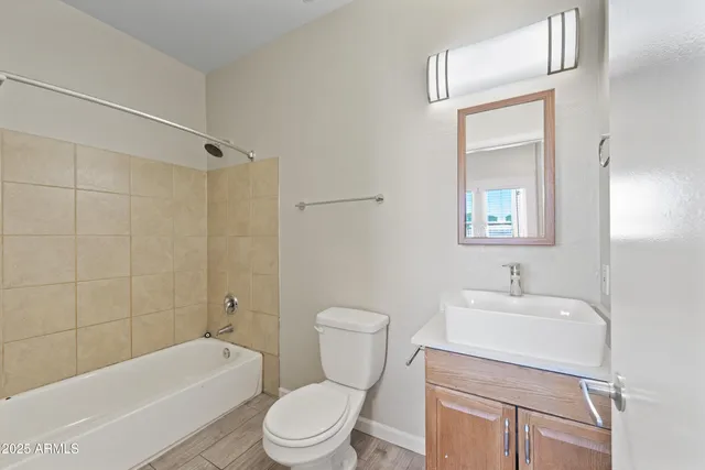 a bathroom with a toilet a sink and bathtub