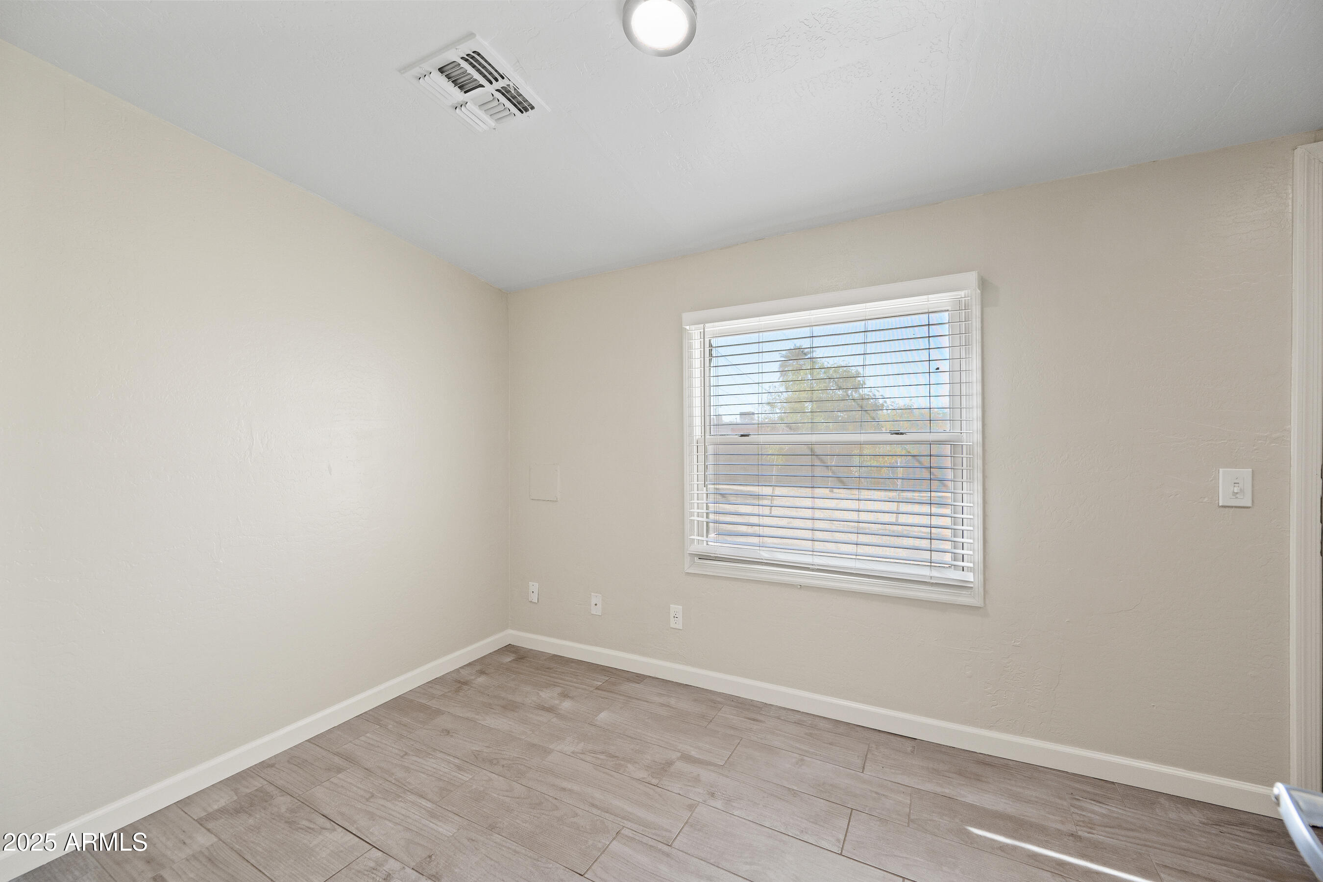 438 North 17th Avenue, Unit A Phoenix, AZ 85007 - Photo 13 of 20 a view of an empty room with a window
