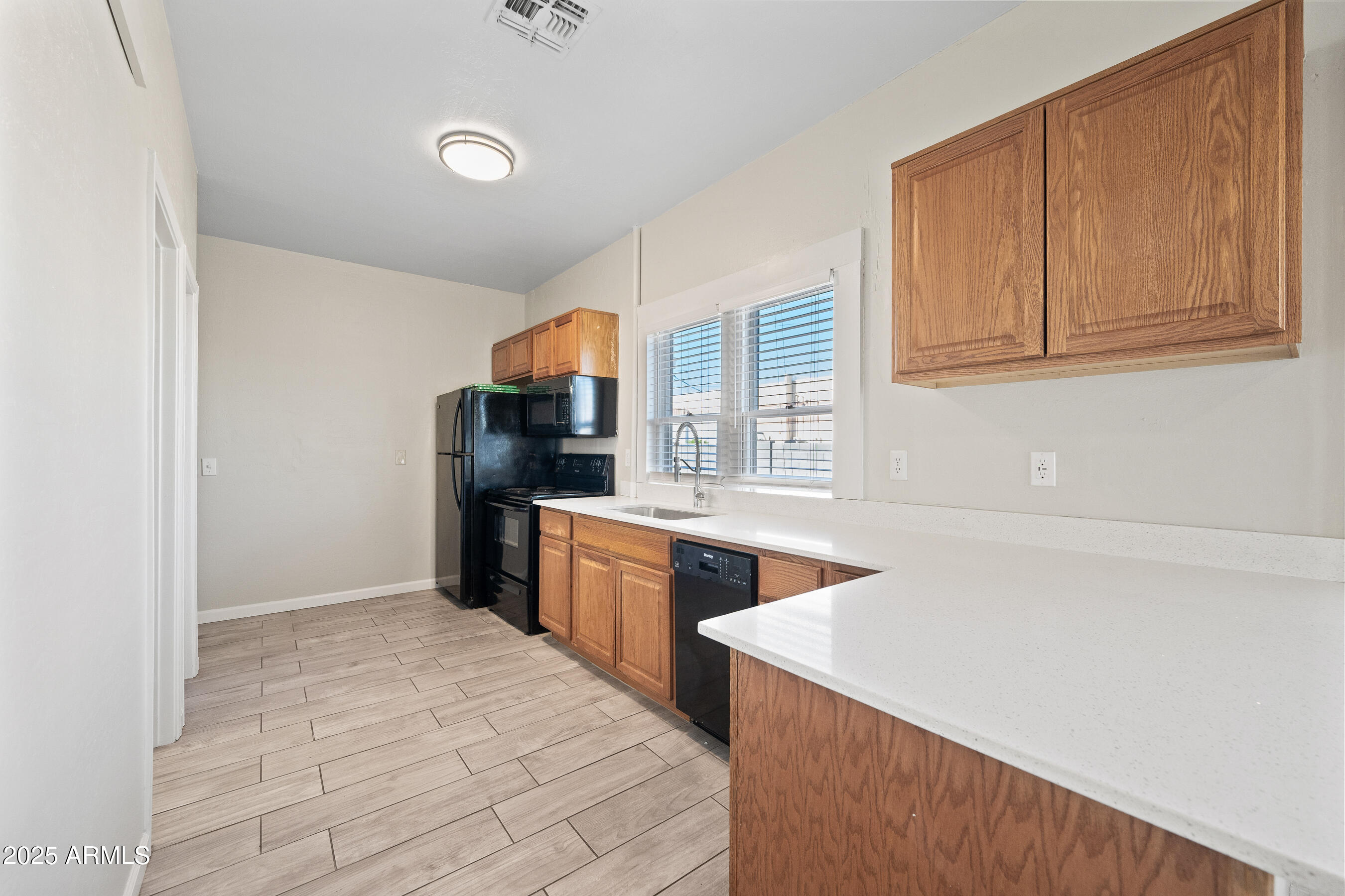 438 North 17th Avenue, Unit A Phoenix, AZ 85007 - Photo 7 of 20 a kitchen with stainless steel appliances granite countertop a refrigerator and a stove top oven