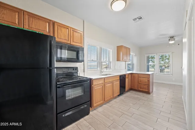 a kitchen with stainless steel appliances granite countertop a stove a sink dishwasher and a refrigerator
