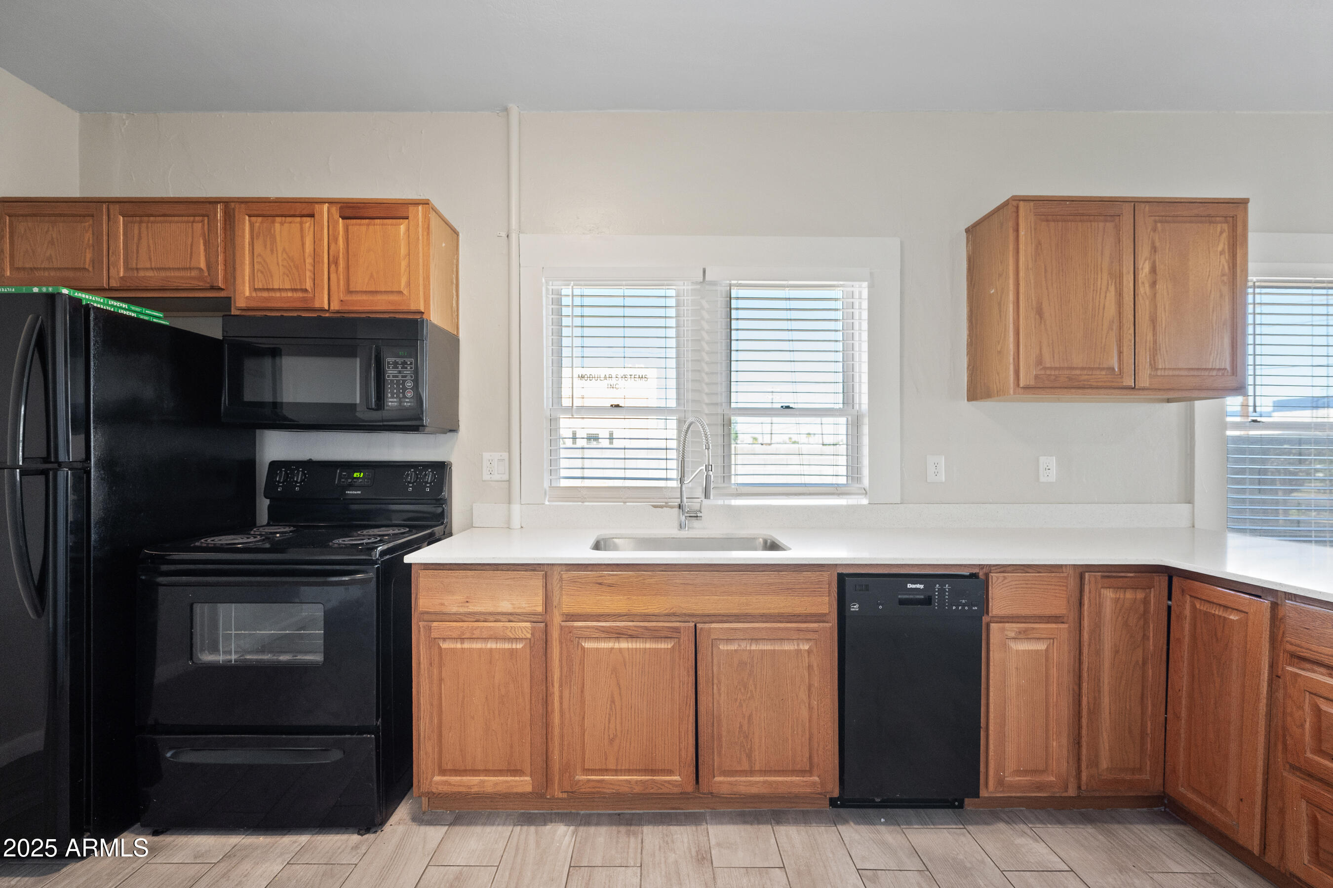 438 North 17th Avenue, Unit A Phoenix, AZ 85007 - Photo 9 of 20 a kitchen with stainless steel appliances granite countertop a stove a sink and a microwave