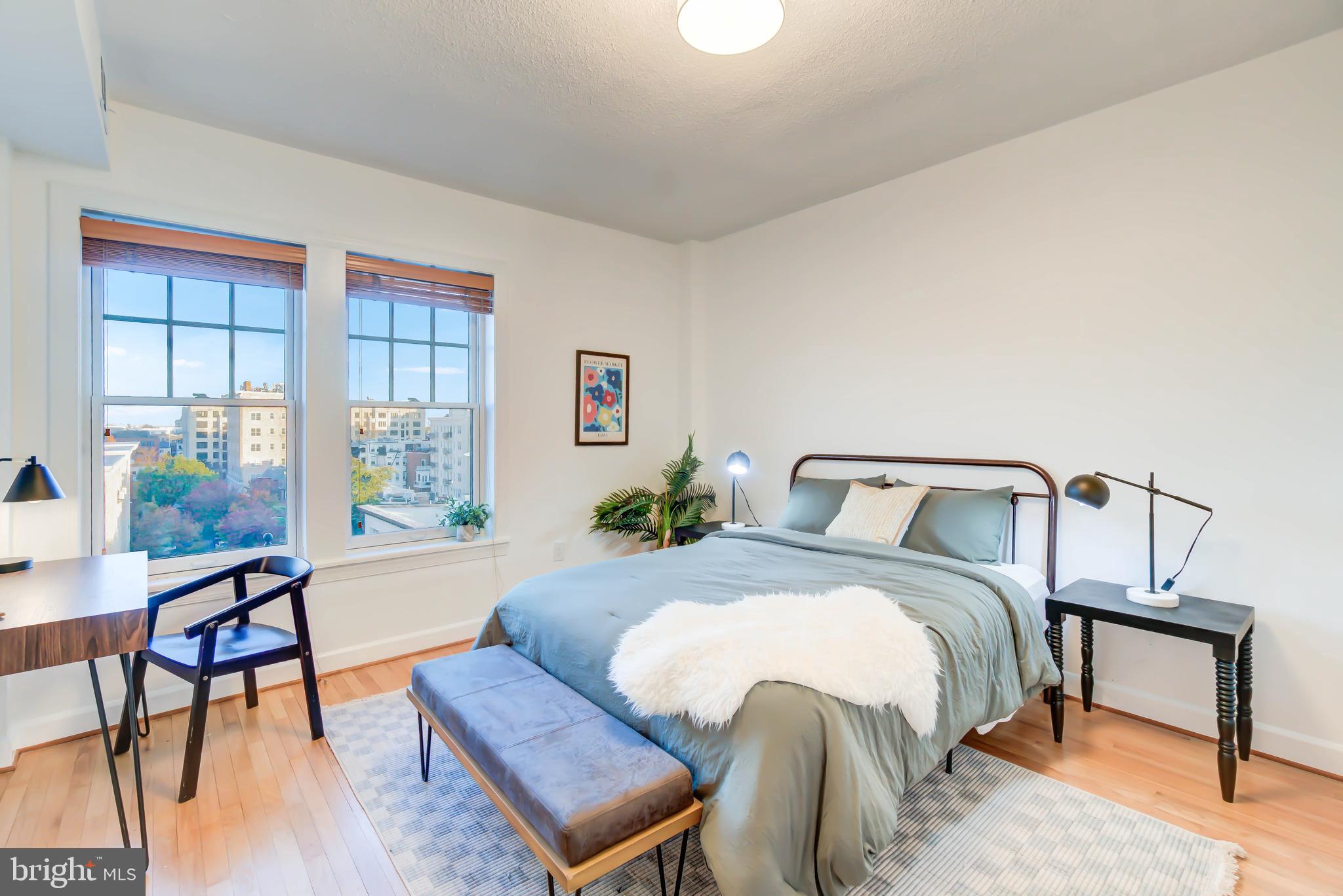 1724 17th Street Northwest, Unit 71 Washington, DC 20009 - Photo 15 of 23 a bedroom with a bed a table and chair with the wooden floor