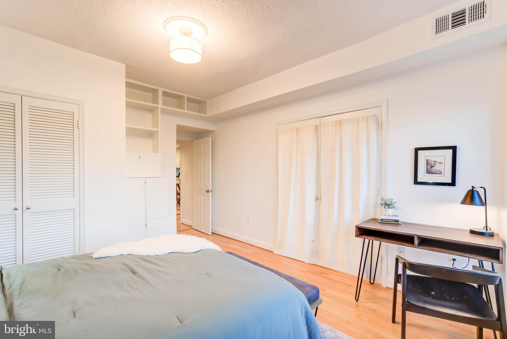 1724 17th Street Northwest, Unit 71 Washington, DC 20009 - Photo 17 of 23 a bedroom with a bed and a desk