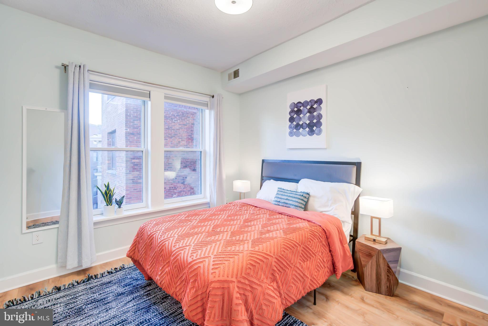 1724 17th Street Northwest, Unit 71 Washington, DC 20009 - Photo 18 of 23 a bed sitting in a bedroom next to a window
