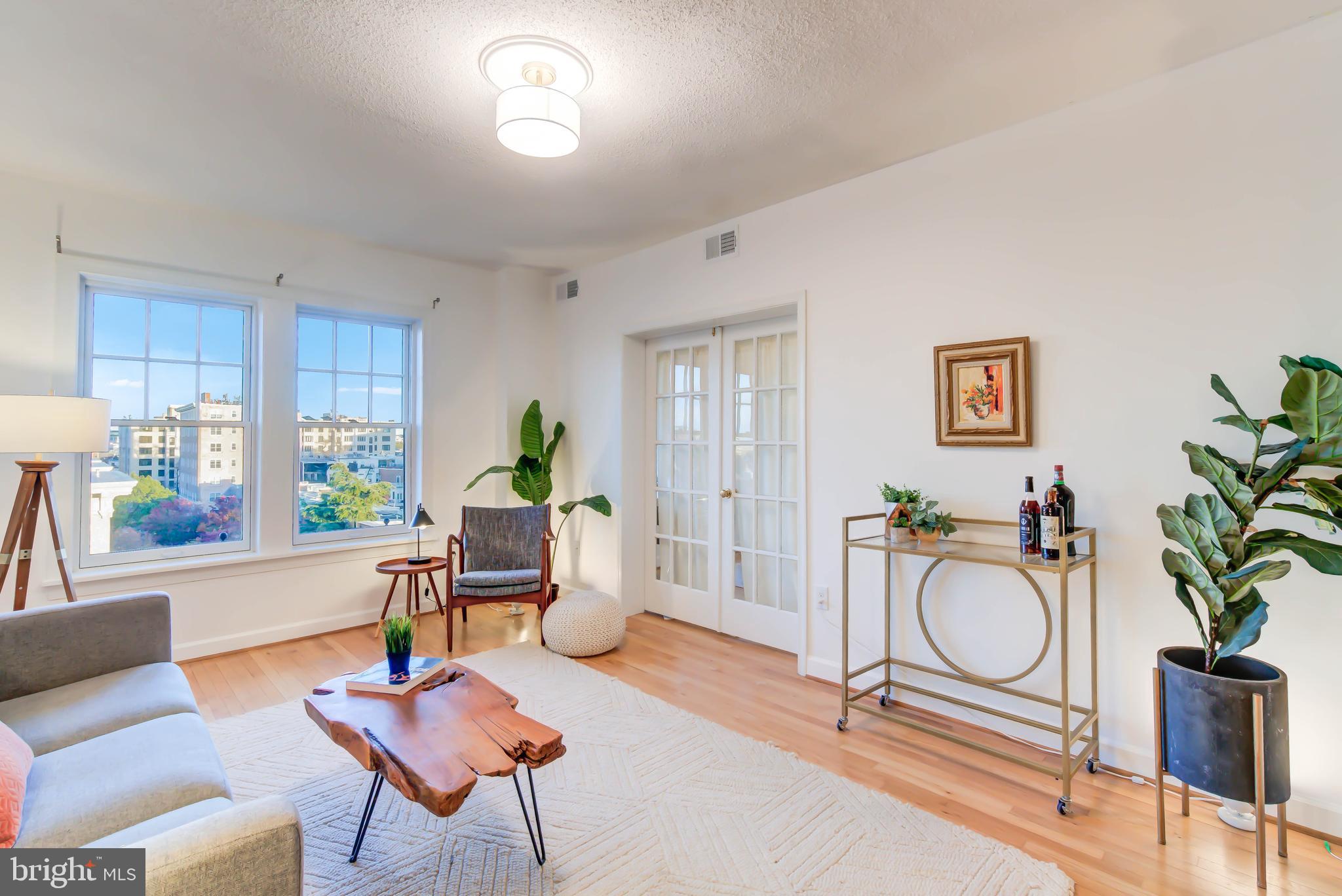1724 17th Street Northwest, Unit 71 Washington, DC 20009 - Photo 3 of 23 a living room with furniture a window and a chandelier