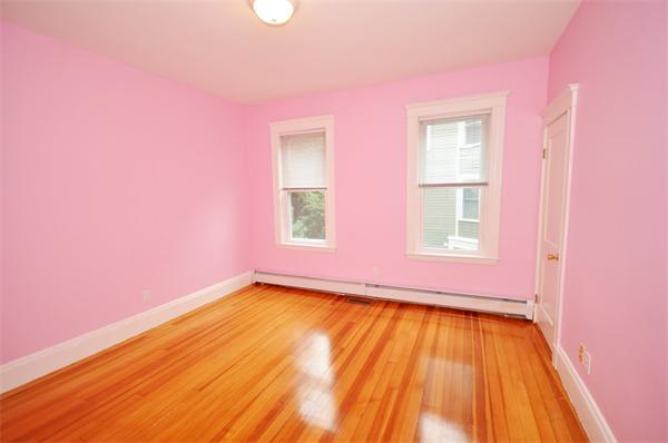 194 Rawson Road, Unit 1 Brookline, MA 02445 - Photo 16 of 20 a view of empty room with wooden floor and fan