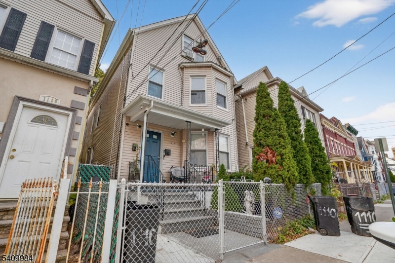 1110 Hampton Place Elizabeth, NJ 07201 - Photo 1 of 23 a view of a brick house with large windows and a flower plants