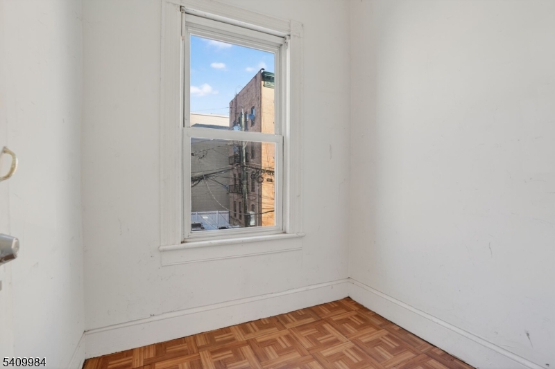 1110 Hampton Place Elizabeth, NJ 07201 - Photo 13 of 23 a view of an empty room with wooden floor and a window