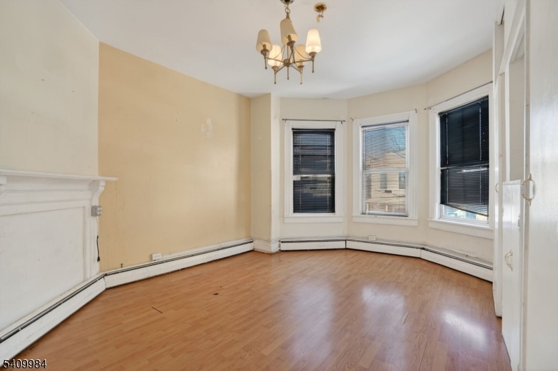 1110 Hampton Place Elizabeth, NJ 07201 - Photo 15 of 23 a view of an empty room with a window and wooden floor