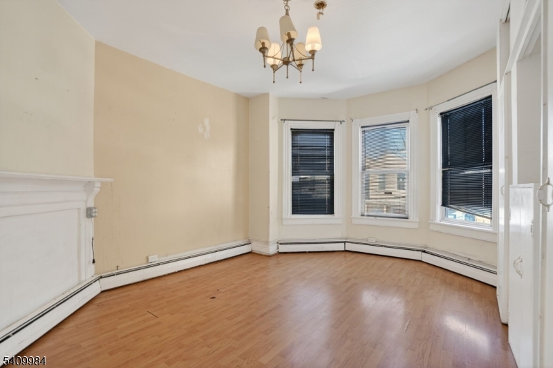 1110 Hampton Place Elizabeth, NJ 07201 - Photo 17 of 23 a view of an empty room with a window and wooden floor