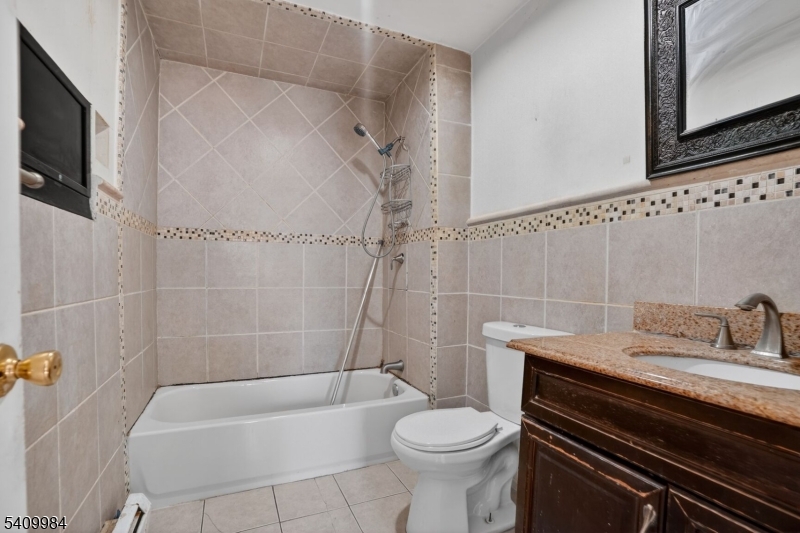 1110 Hampton Place Elizabeth, NJ 07201 - Photo 19 of 23 a bathroom with a sink a toilet a mirror and bathtub