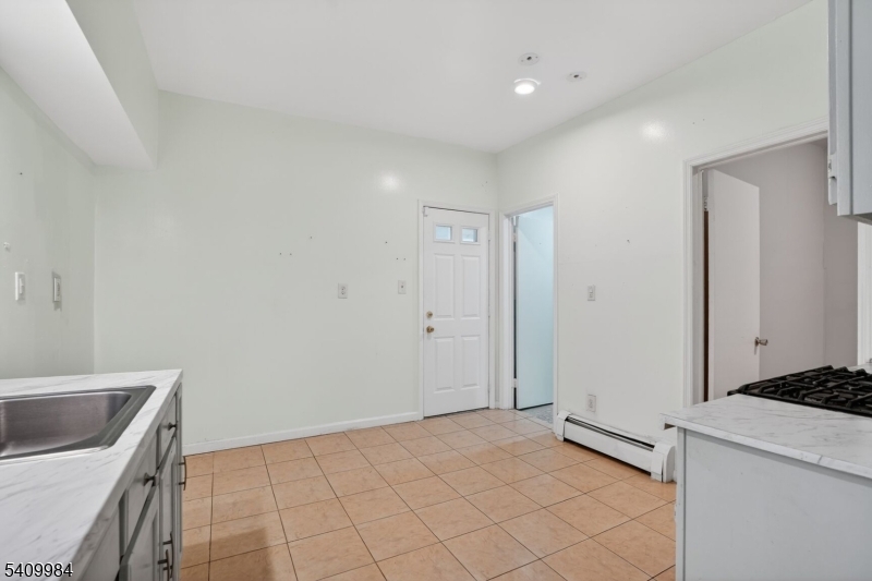 1110 Hampton Place Elizabeth, NJ 07201 - Photo 3 of 23 a view of a kitchen with a sink dishwasher and wooden floor