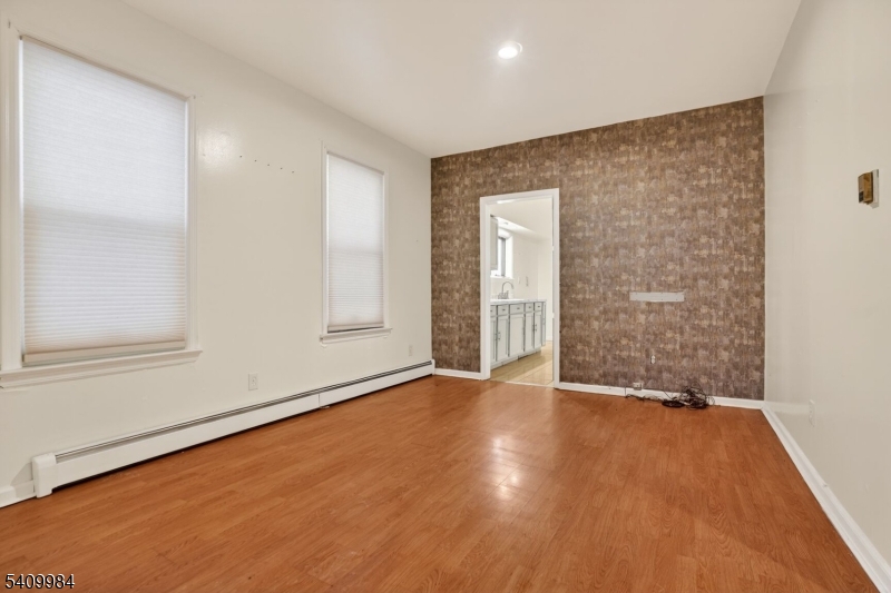 1110 Hampton Place Elizabeth, NJ 07201 - Photo 8 of 23 a view of an empty room with wooden floor and a window