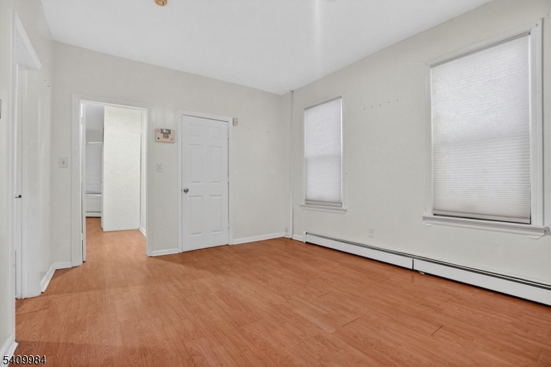1110 Hampton Place Elizabeth, NJ 07201 - Photo 9 of 23 a view of an empty room with wooden floor