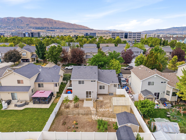 392 West Bricker Road Draper, UT 84020 - Photo 28 of 33 Rear exterior featuring a patio, an enclosed backyard with a white fence, and a detached storage shed