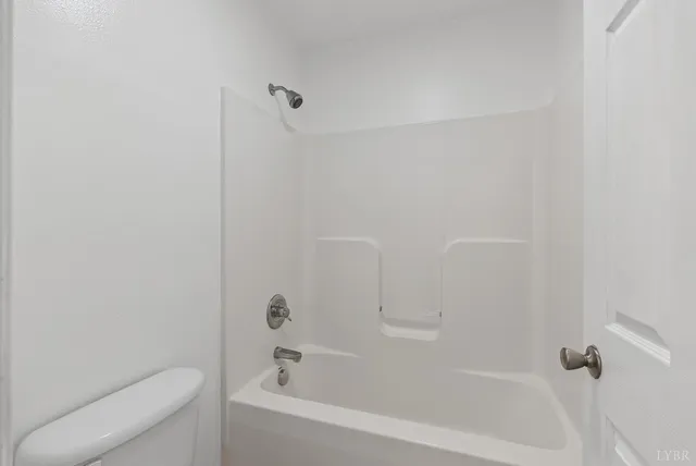 a bathroom with a bathtub and toilet