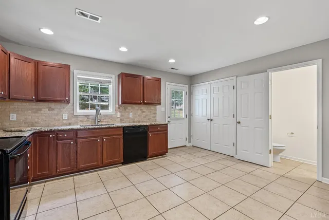 a large kitchen with a sink and cabinets