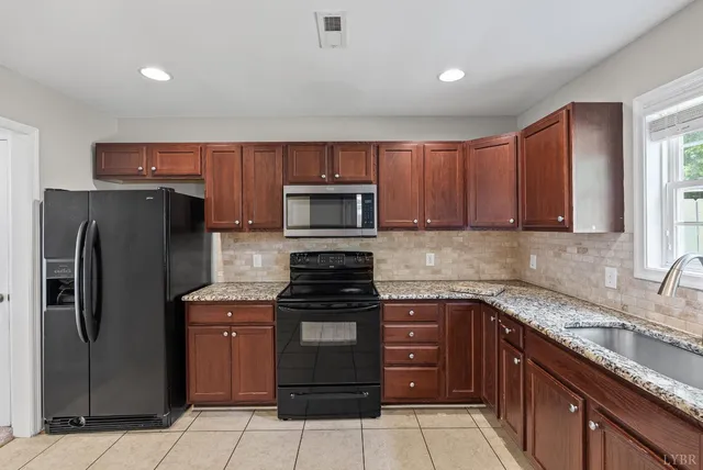a kitchen with a refrigerator stove and sink