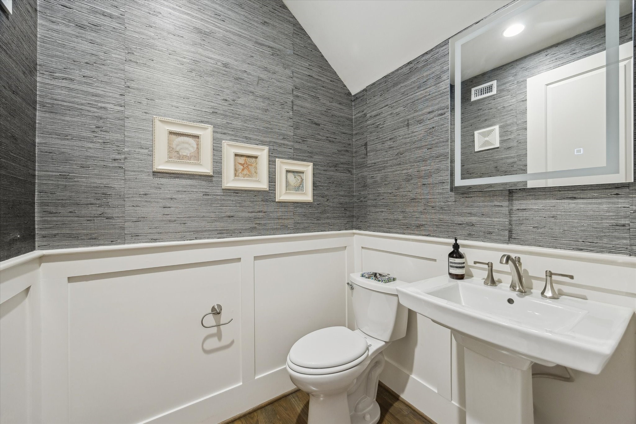 1547 Nevada Street Houston, TX 77006 - Photo 12 of 23 a bathroom with a toilet sink and mirror