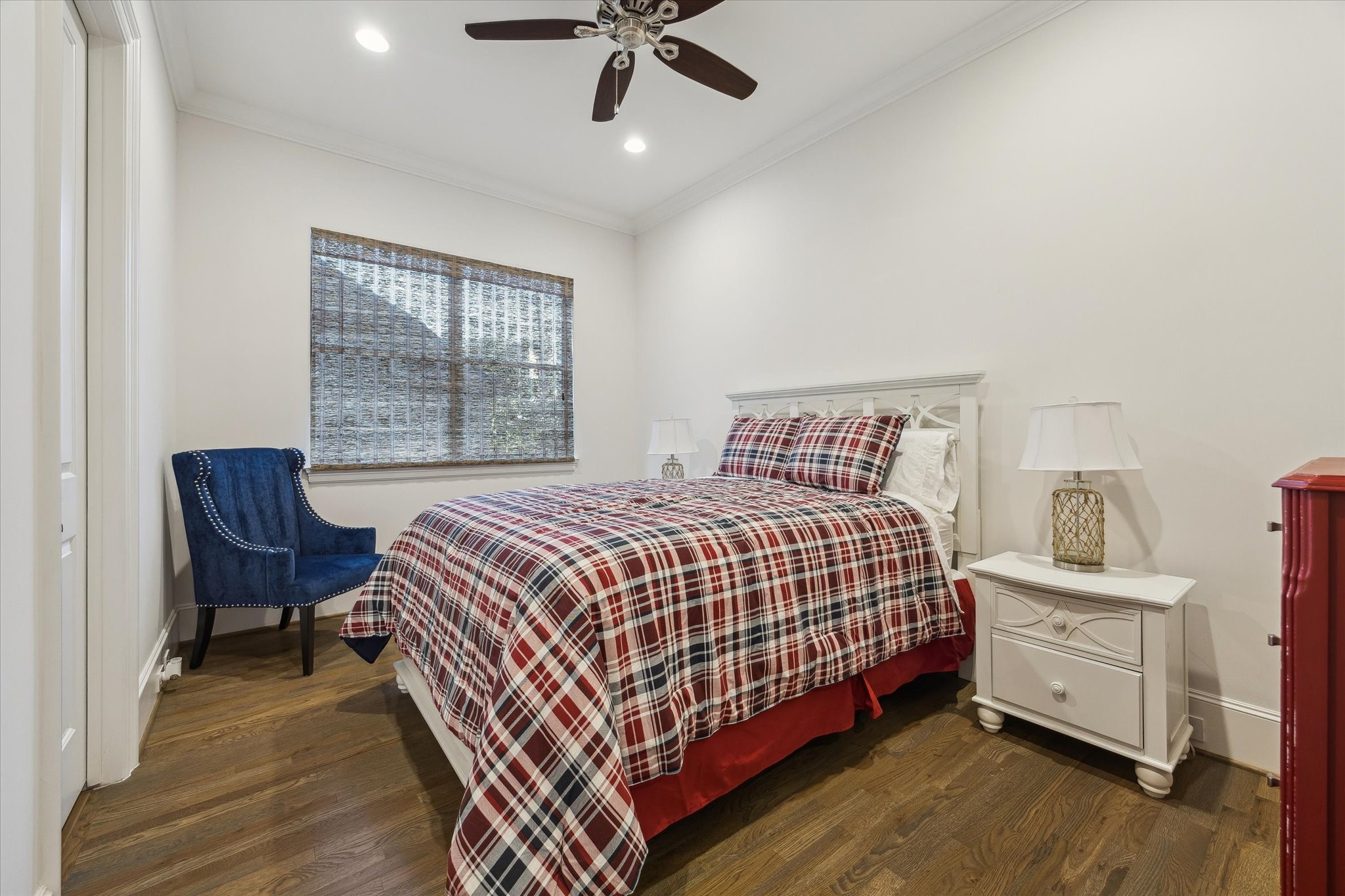 1547 Nevada Street Houston, TX 77006 - Photo 12 of 24 a bedroom with a bed and a chair