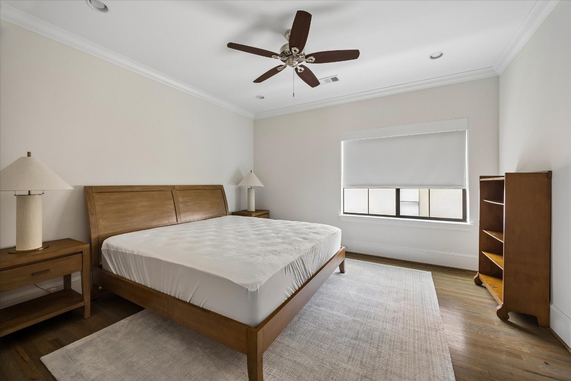 1547 Nevada Street Houston, TX 77006 - Photo 15 of 23 a bedroom with a bed a window and a flat screen tv