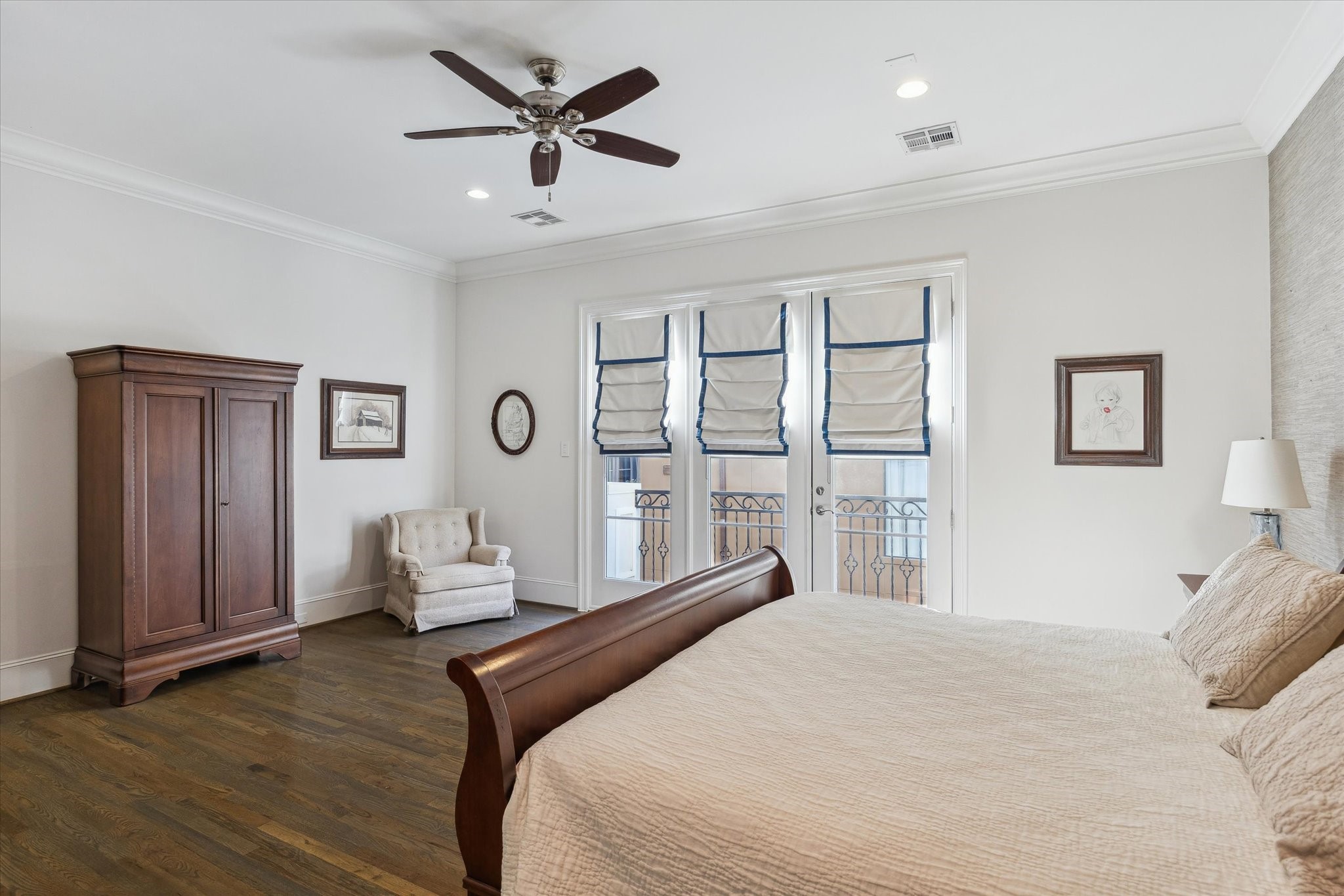 1547 Nevada Street Houston, TX 77006 - Photo 15 of 24 a bedroom with a large bed and a chandelier