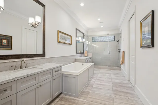 a bathroom with a sink a toilet a mirror and shower