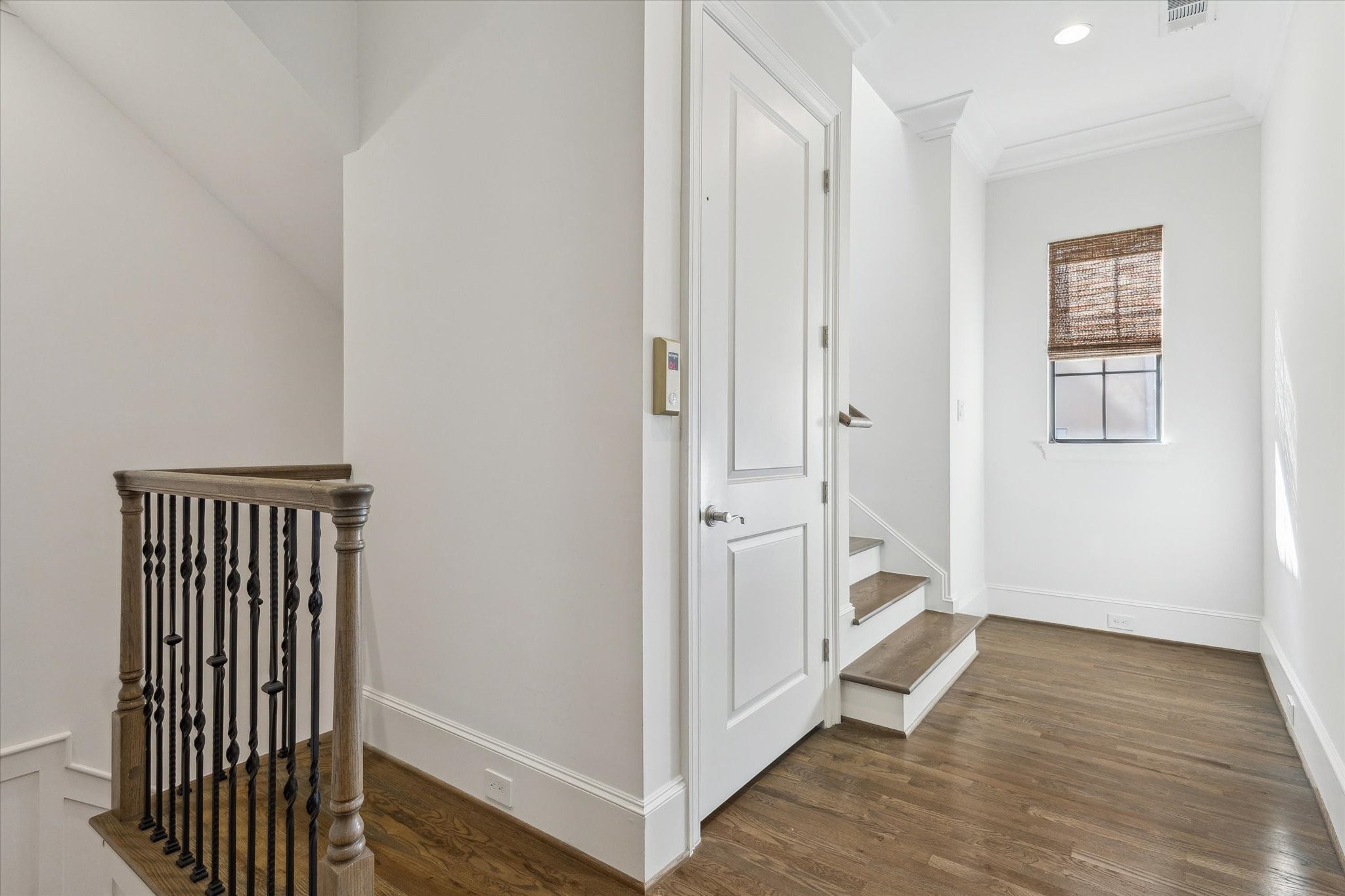 1547 Nevada Street Houston, TX 77006 - Photo 17 of 24 a view of a hallway with wooden floor and a bathroom