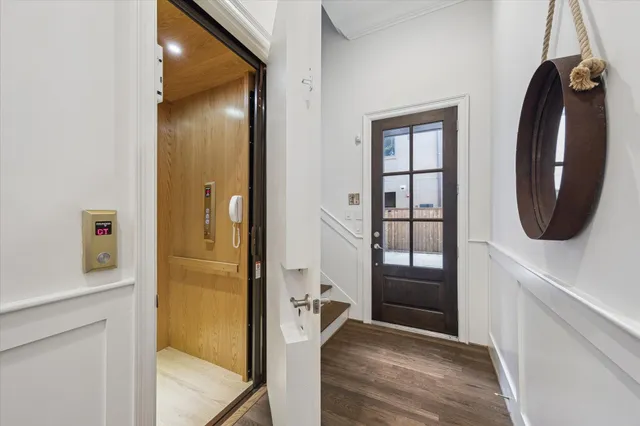 a view of a hallway with wooden floor and windows