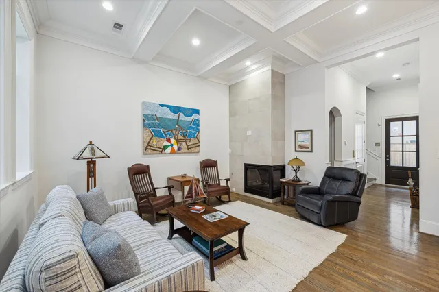 a living room with furniture rug and wooden floor