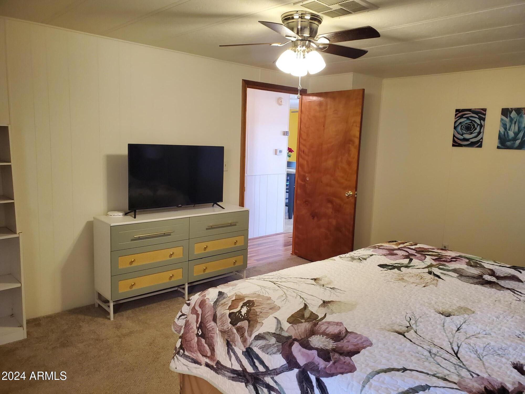 2100 North Trekell Road, Unit 222 Casa Grande, AZ 85122 - Photo 13 of 26 a bedroom with a bed and a flat screen tv