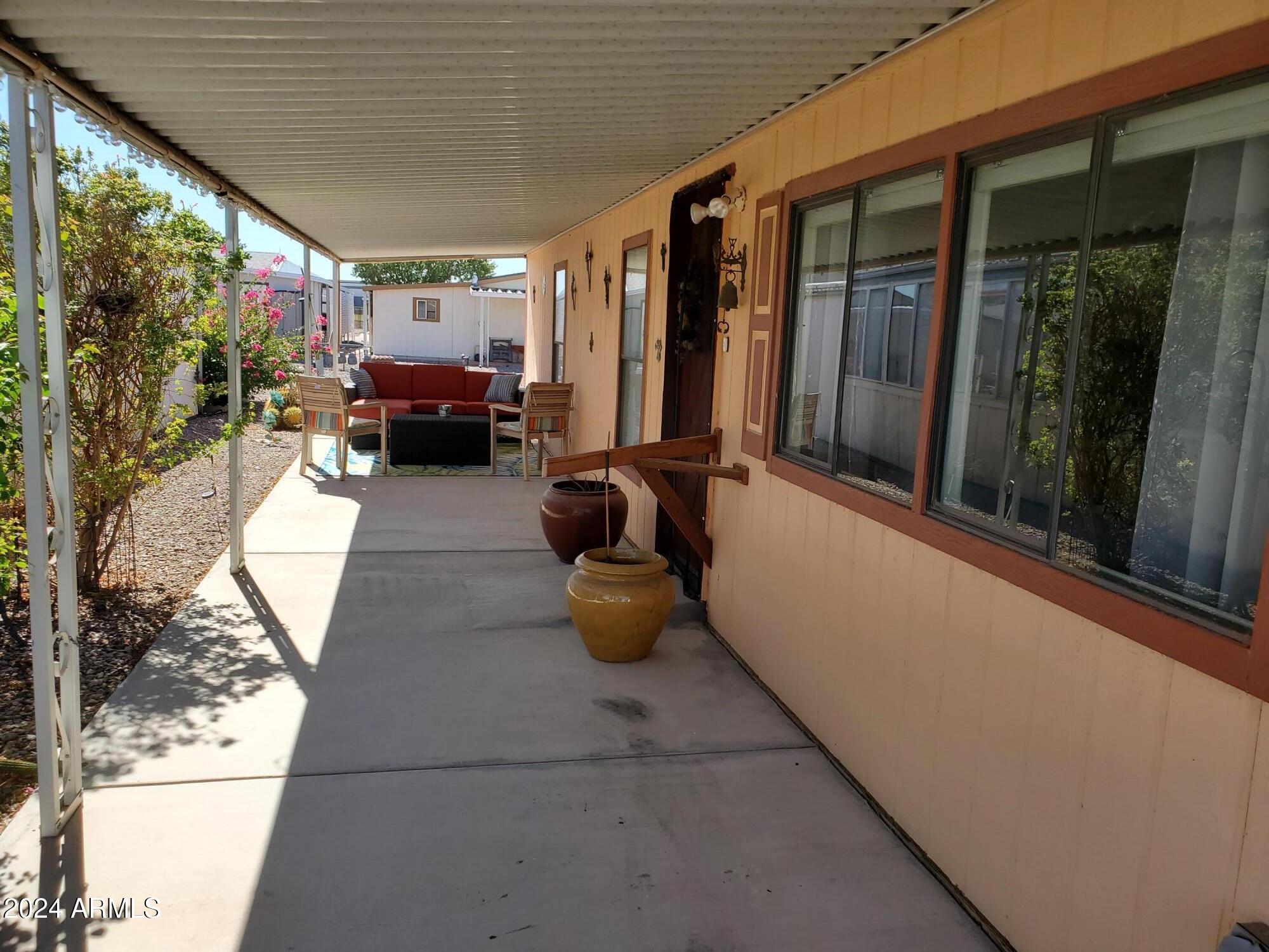 2100 North Trekell Road, Unit 222 Casa Grande, AZ 85122 - Photo 19 of 26 a room with patio furniture and a flat screen tv