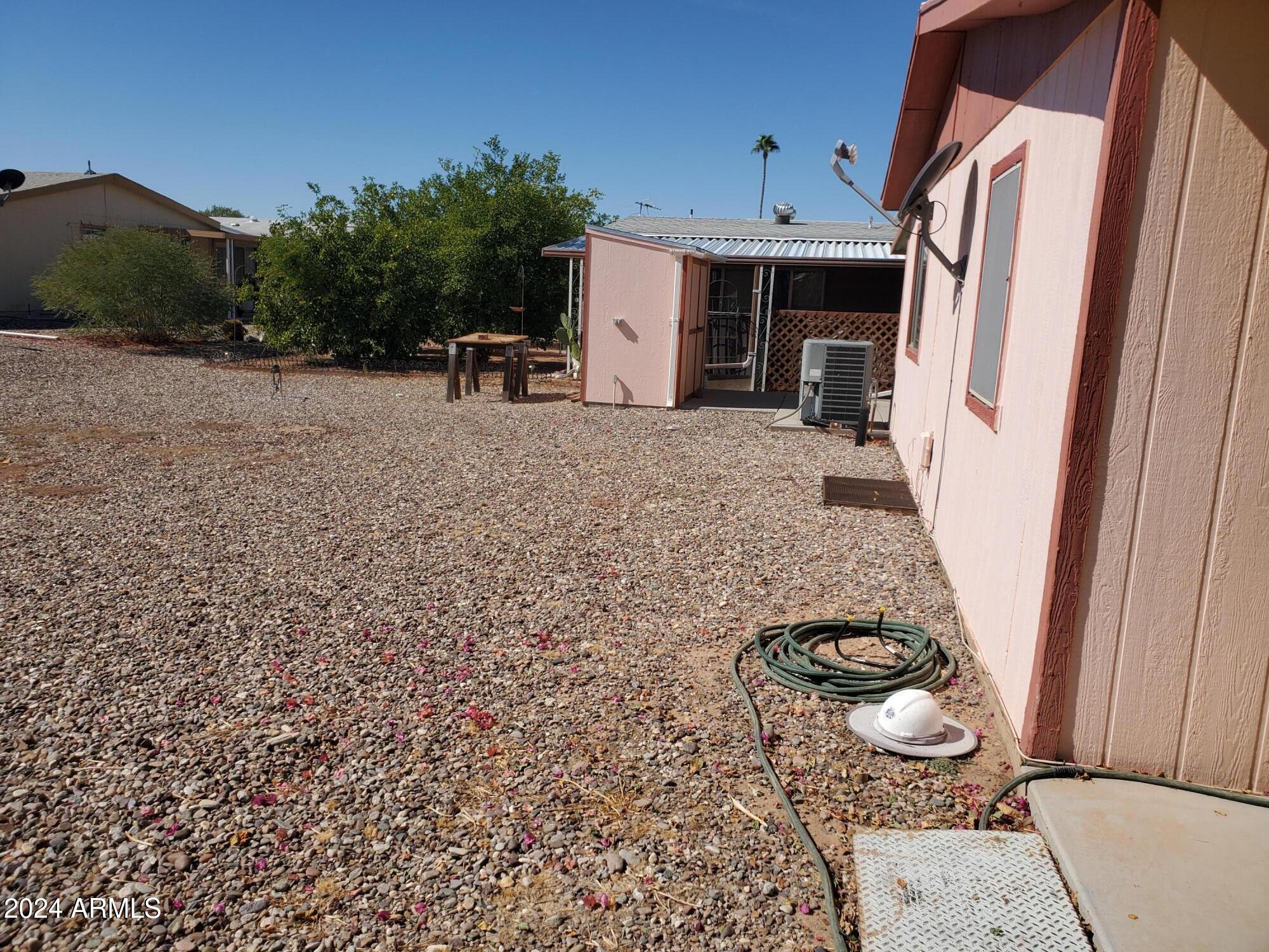 2100 North Trekell Road, Unit 222 Casa Grande, AZ 85122 - Photo 21 of 26 a backyard of a house with table and chairs