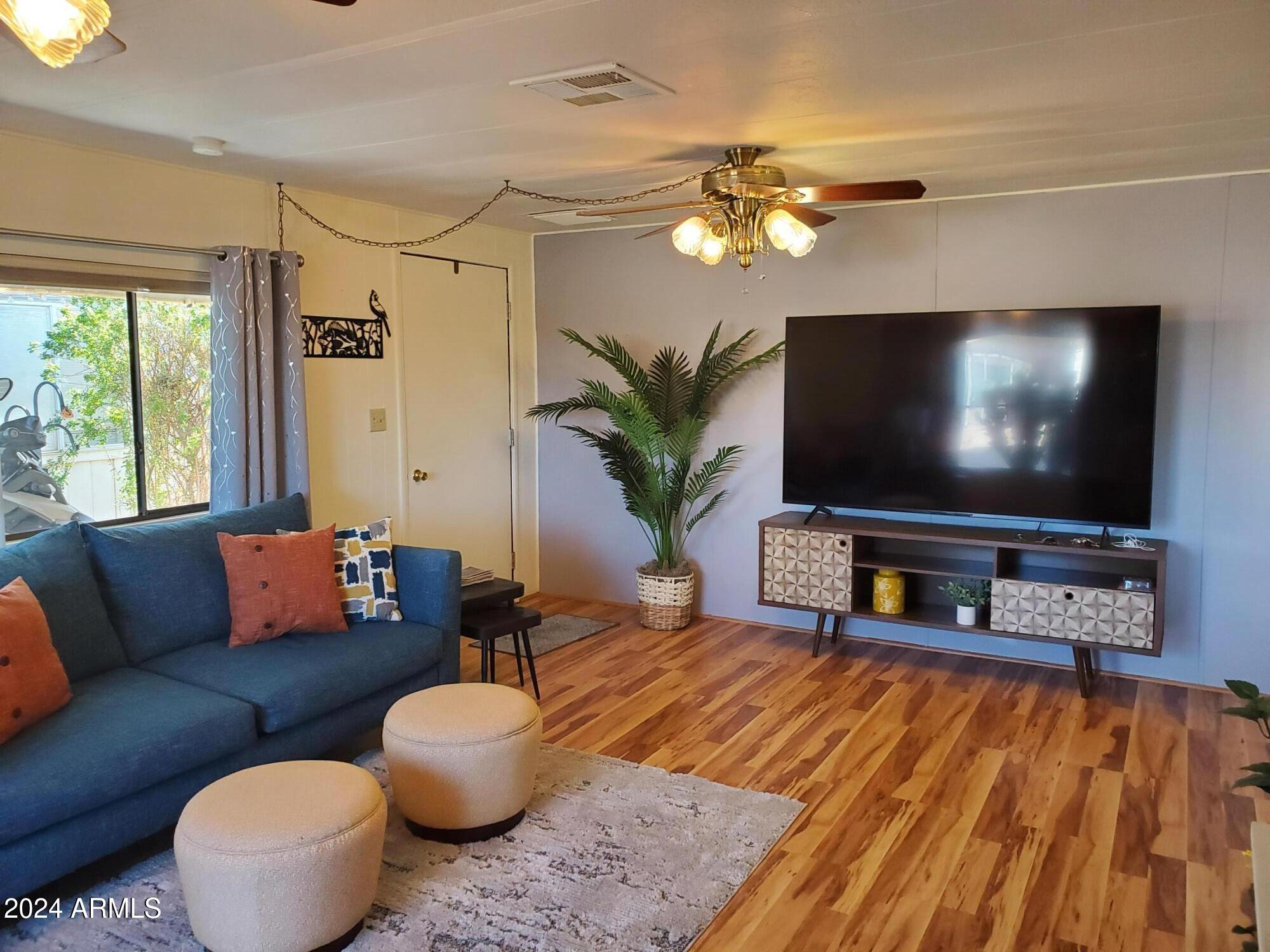 2100 North Trekell Road, Unit 222 Casa Grande, AZ 85122 - Photo 5 of 26 a living room with furniture and a flat screen tv