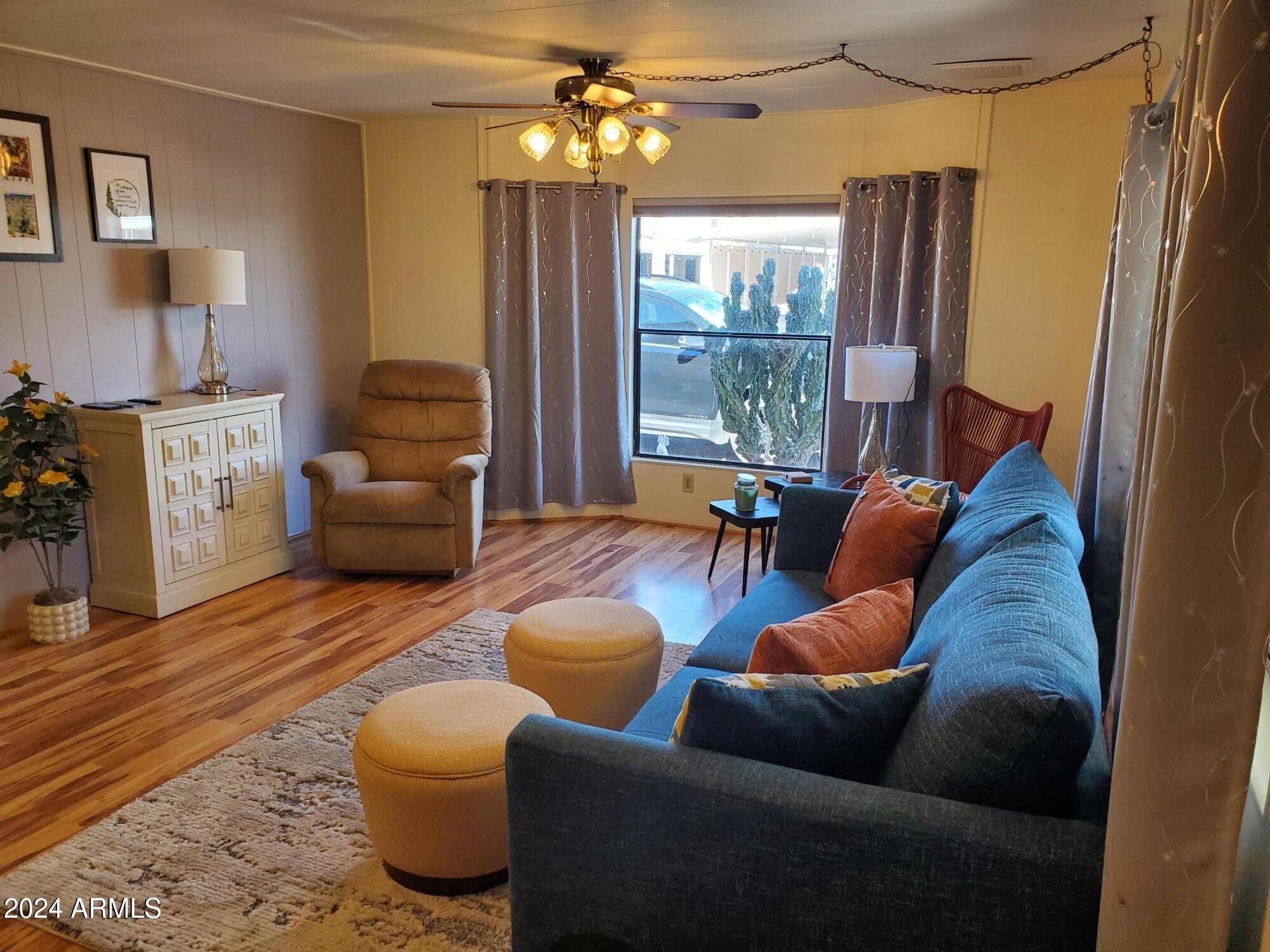 2100 North Trekell Road, Unit 222 Casa Grande, AZ 85122 - Photo 6 of 26 a living room with furniture or chandelier and a wooden floor