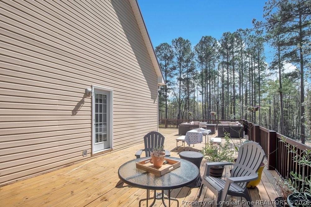 419 Senter Lane Bunnlevel, NC 28323 - Photo 38 of 49 a patio with a table and chairs and potted plants