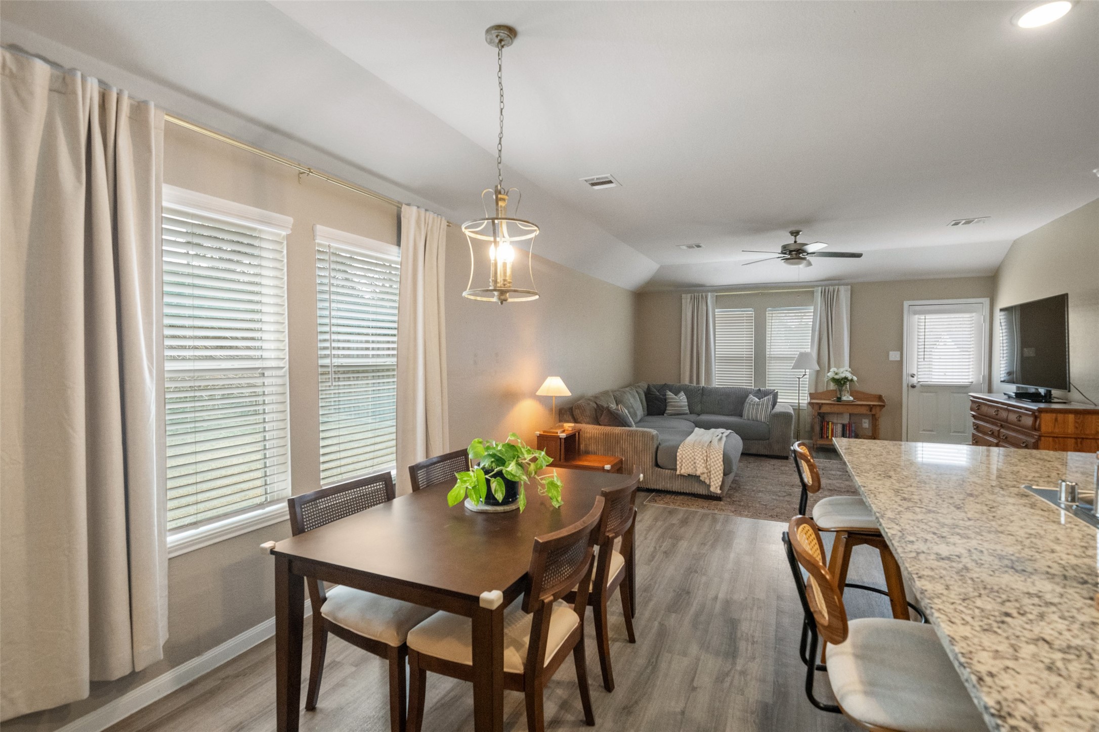 26431 Pin Oak Drive Hempstead, TX 77445 - Photo 10 of 32 Sunny dining area with multiple windows, soft natural light, and modern pendant lighting. Located just off the kitchen for easy hosting and meal prep convenience.