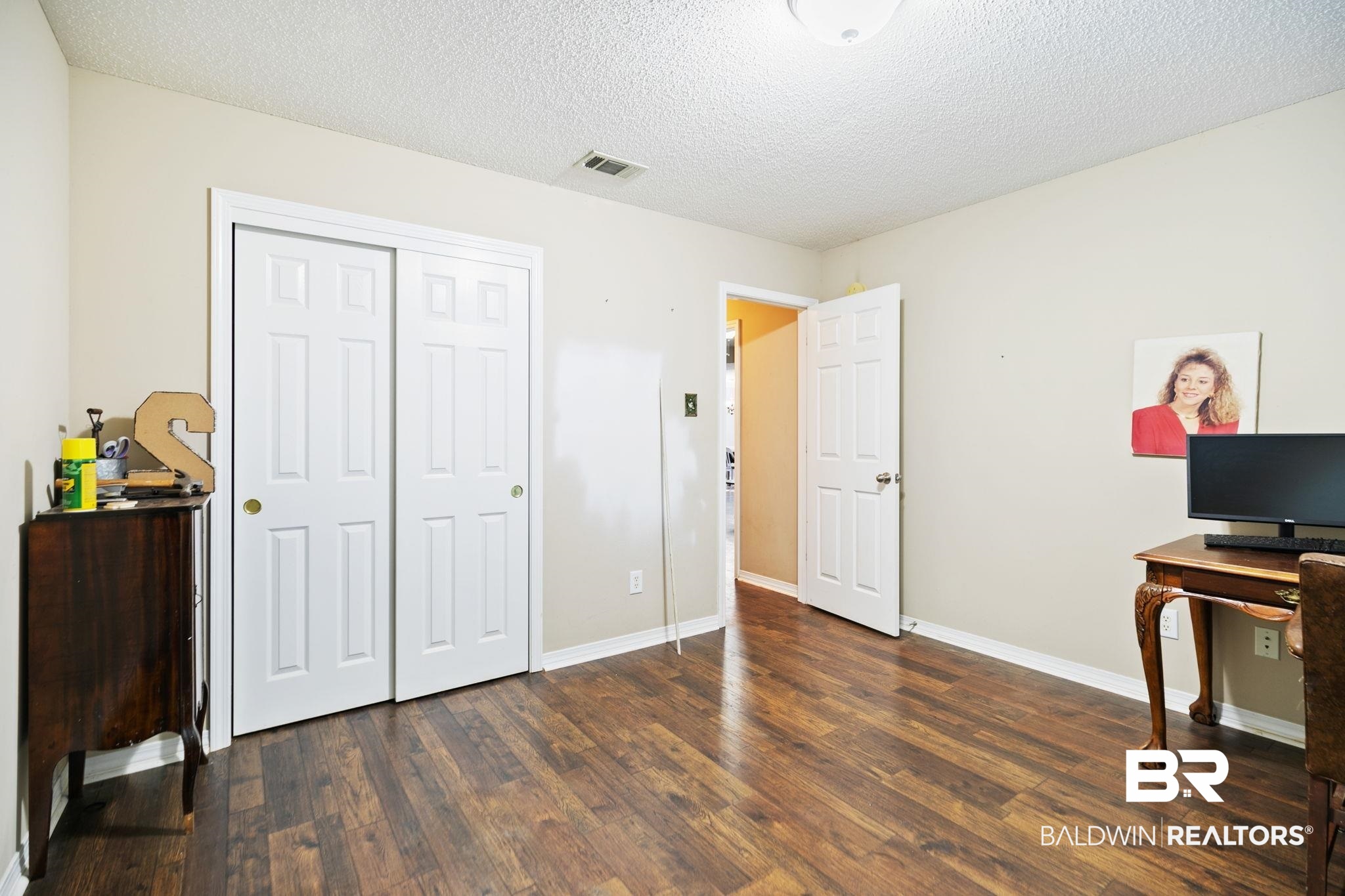 10550 Patrick Avenue Grand Bay, AL 36541 - Photo 31 of 43 Bedroom with a closet, a textured ceiling, and hardwood / wood-style flooring