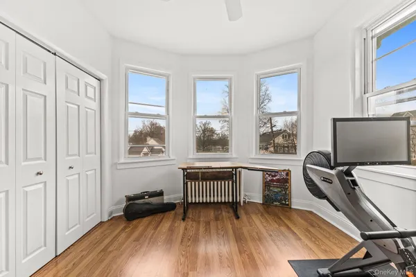 a view of a workspace with furniture and a window